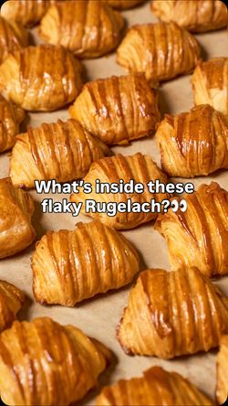 Flaky golden-brown rugelach pastries arranged closely on a baking sheet at Breads Bakery – Union Square.