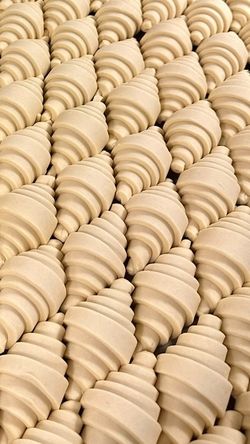 Rows of unbaked croissant dough arranged closely together at Breads Bakery – Bryant Park.