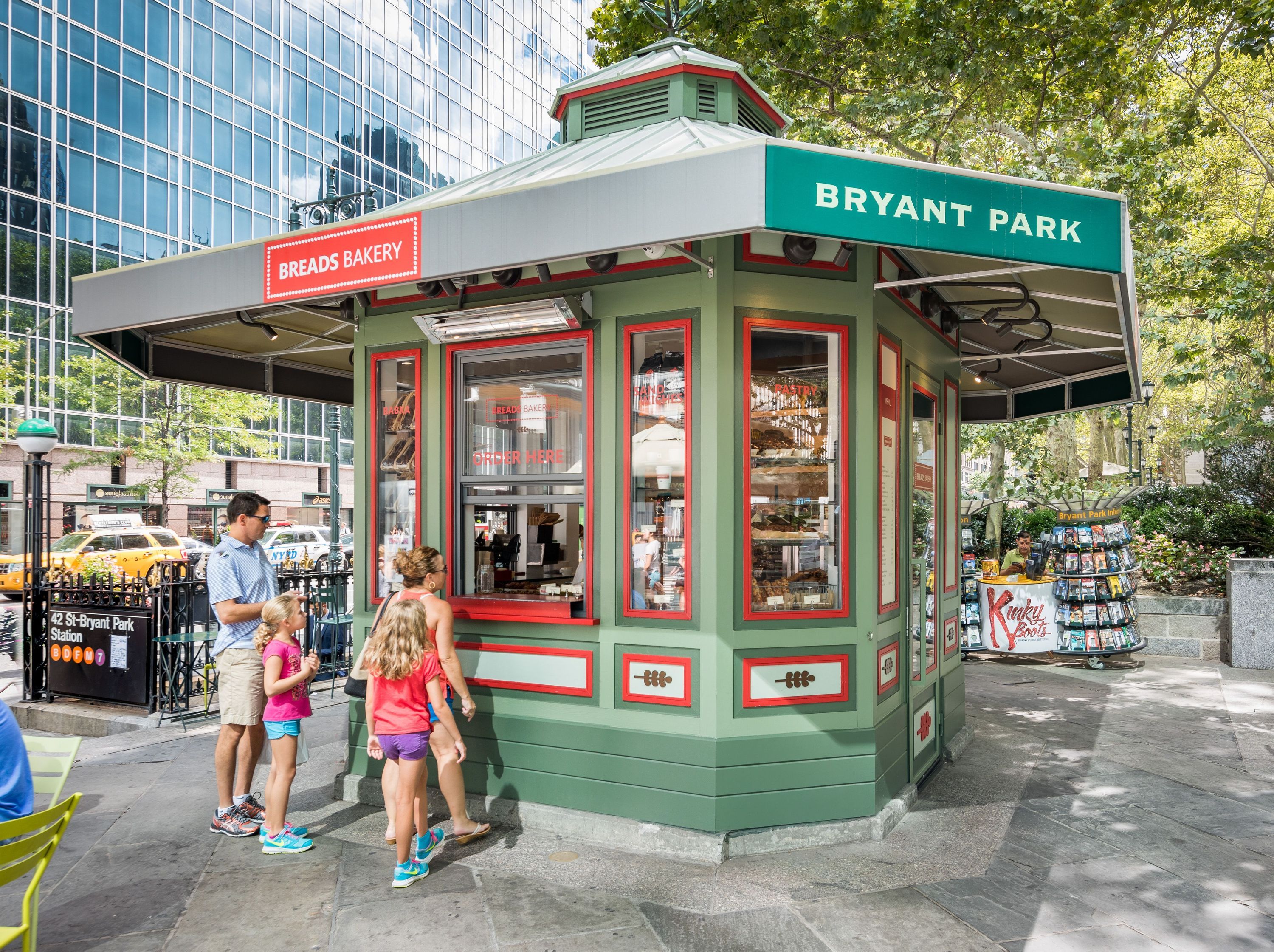 Breads Bakery in Bryant Park features a charming kiosk offering pastries, bread, coffee, and breakfast items.