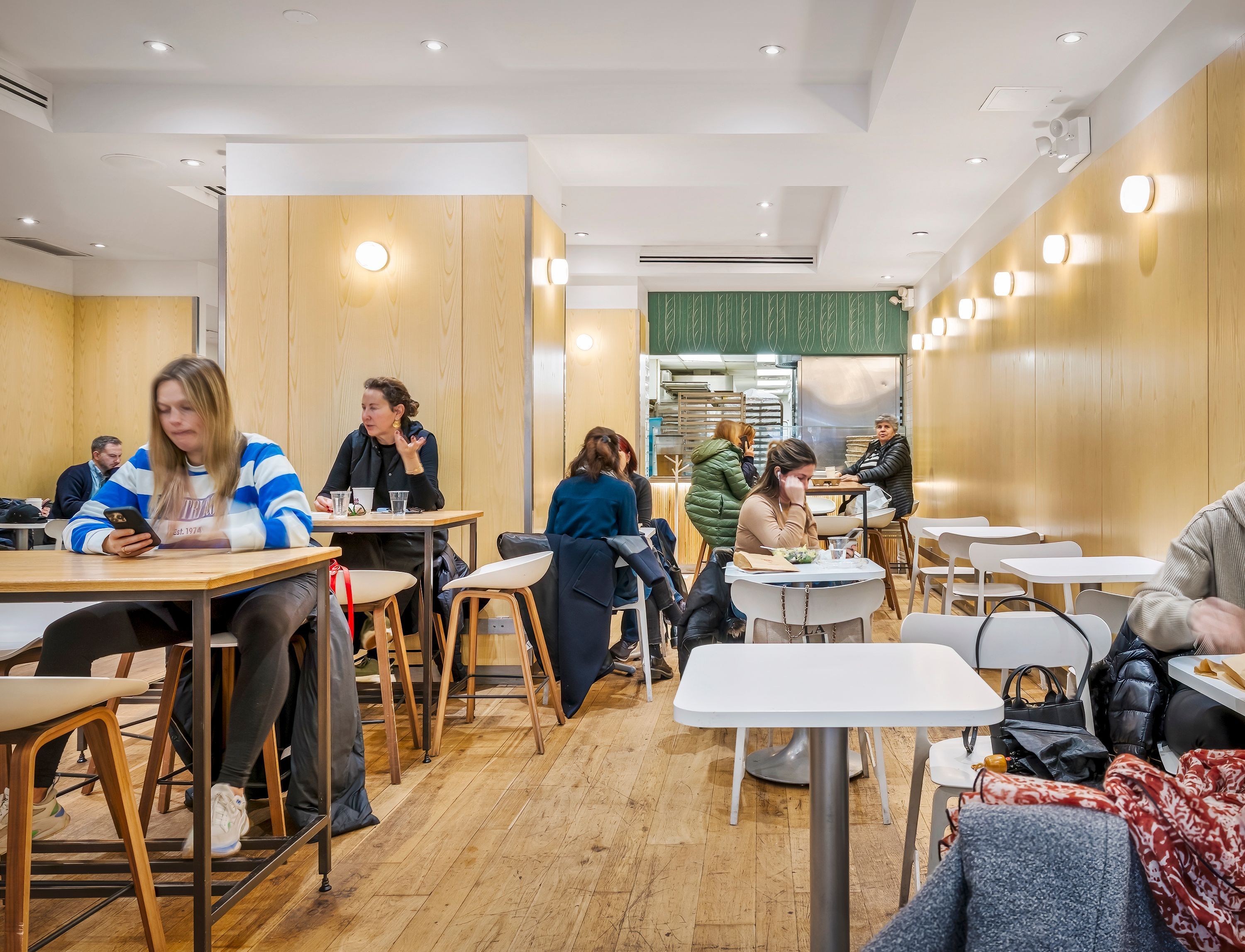 Modern and inviting interior of Breads Bakery, filled with customers enjoying pastries and coffee.