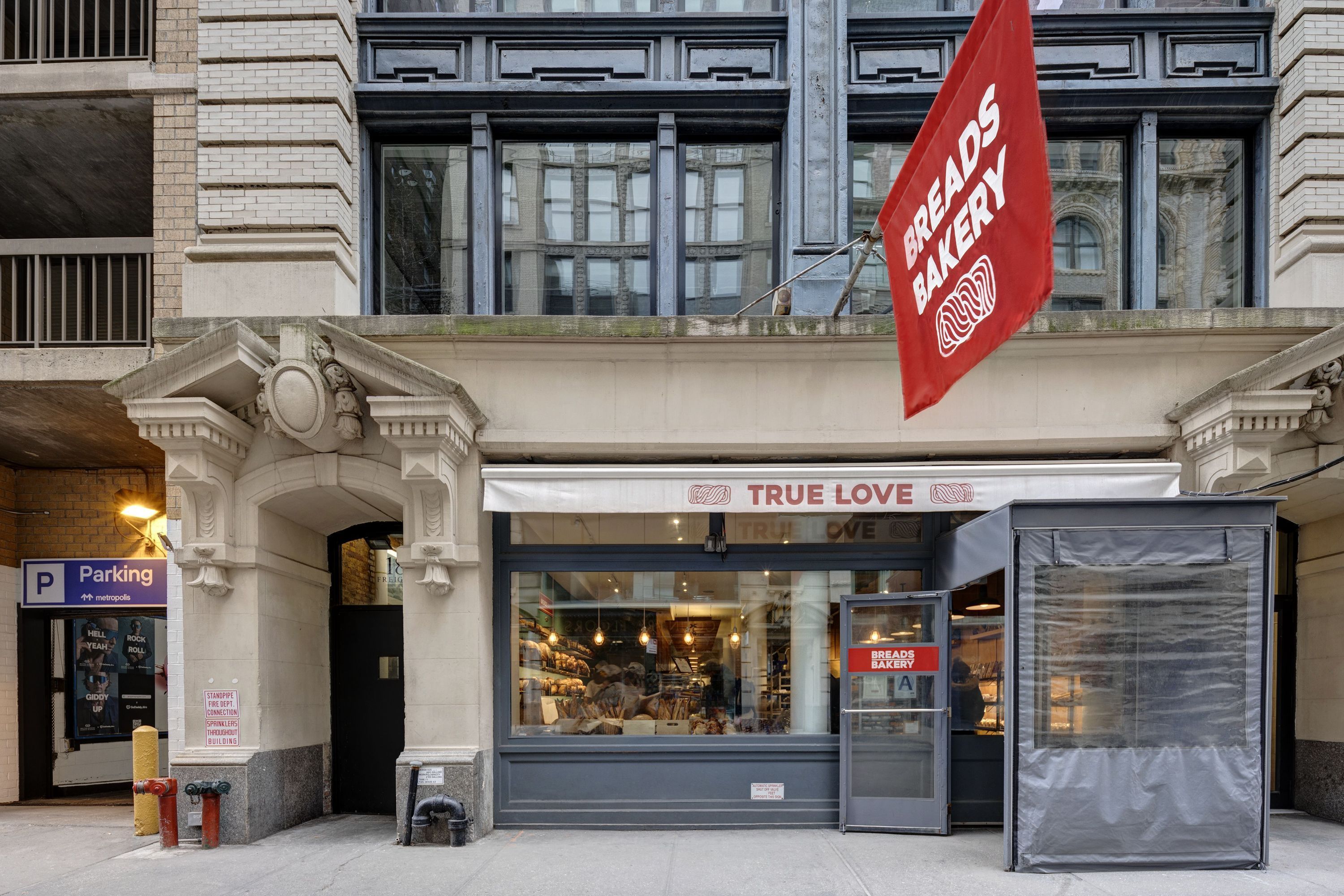 Breads Bakery features a welcoming exterior with its prominent sign and large windows showcasing baked goods.
