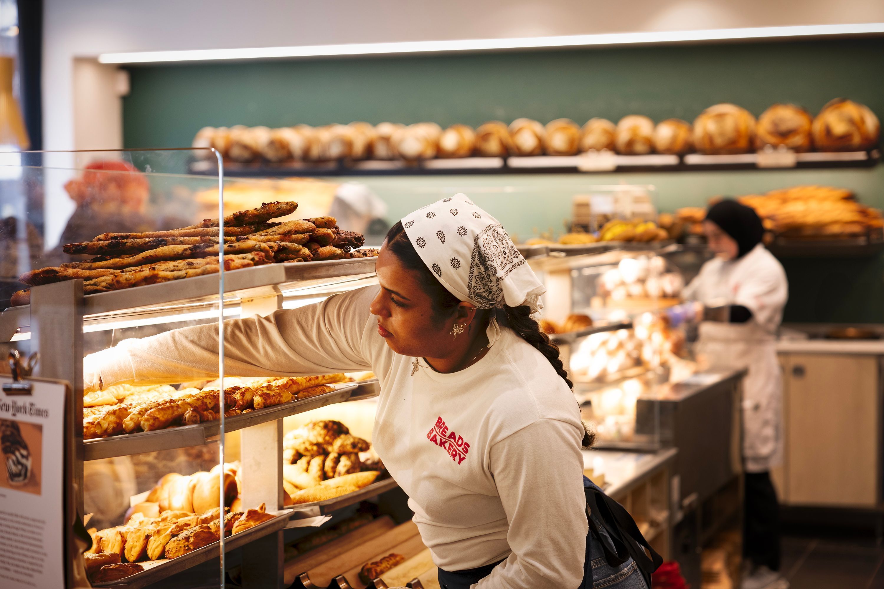 A bustling bakery display showcasing various pastries, bread, and baked goods at Breads Bakery.