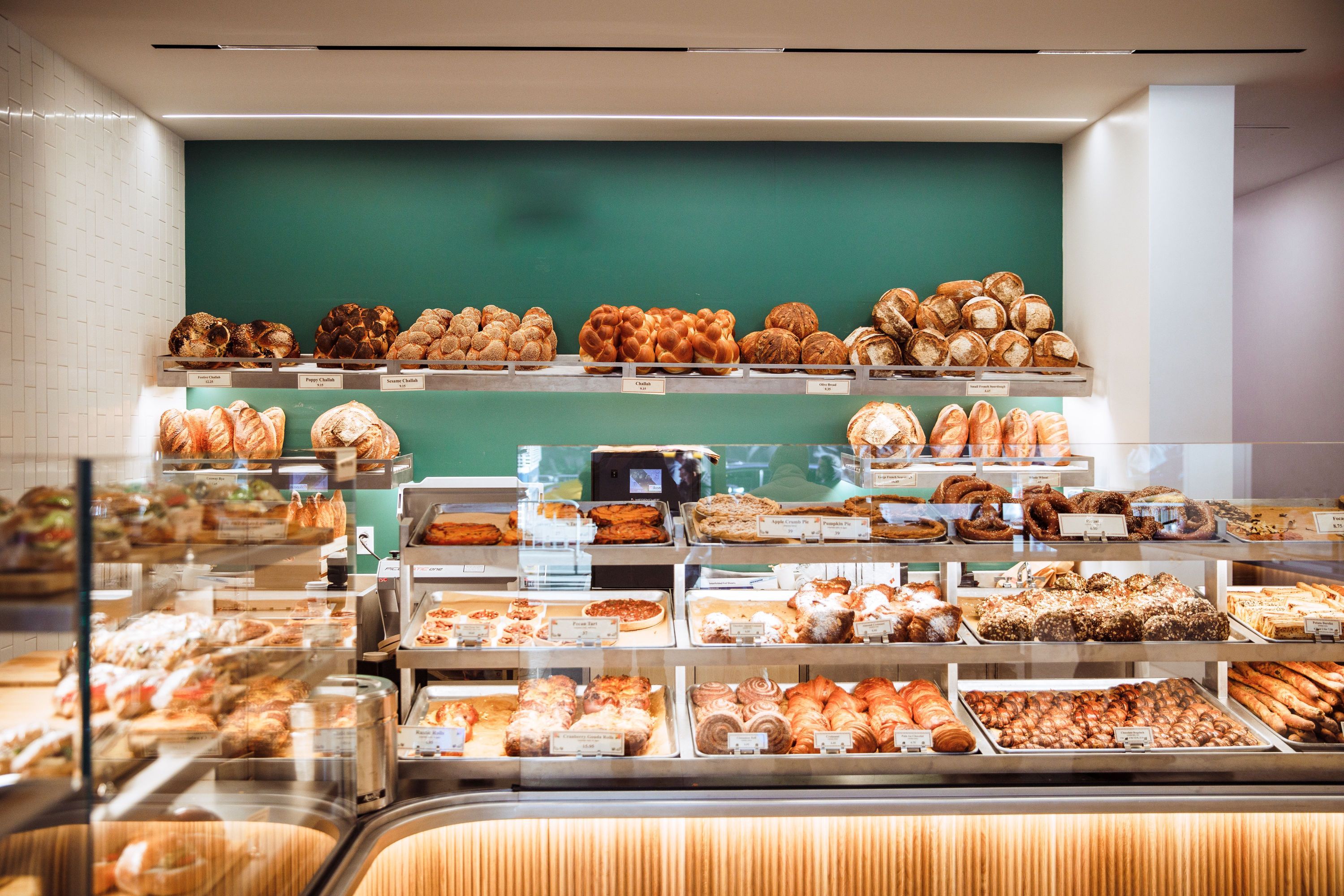 A display of various baked goods including pastries, breads, and sweets at Breads Bakery.